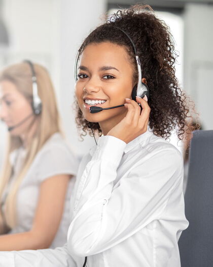 Büroservice-Mitarbeiterin bei der Arbeit mit einem Headset.